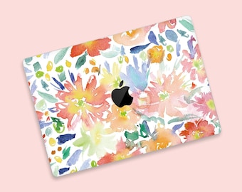 May include: A laptop skin with a watercolour floral design featuring pink, yellow, blue, and green flowers on a white background. The Apple logo is visible in the centre of the design.