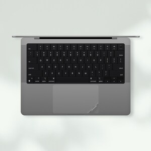 a laptop computer with a black keyboard sitting on top of it