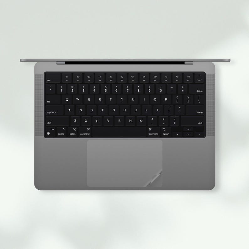 a laptop computer with a black keyboard sitting on top of it