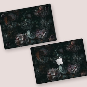 two laptops with a picture of flowers on them