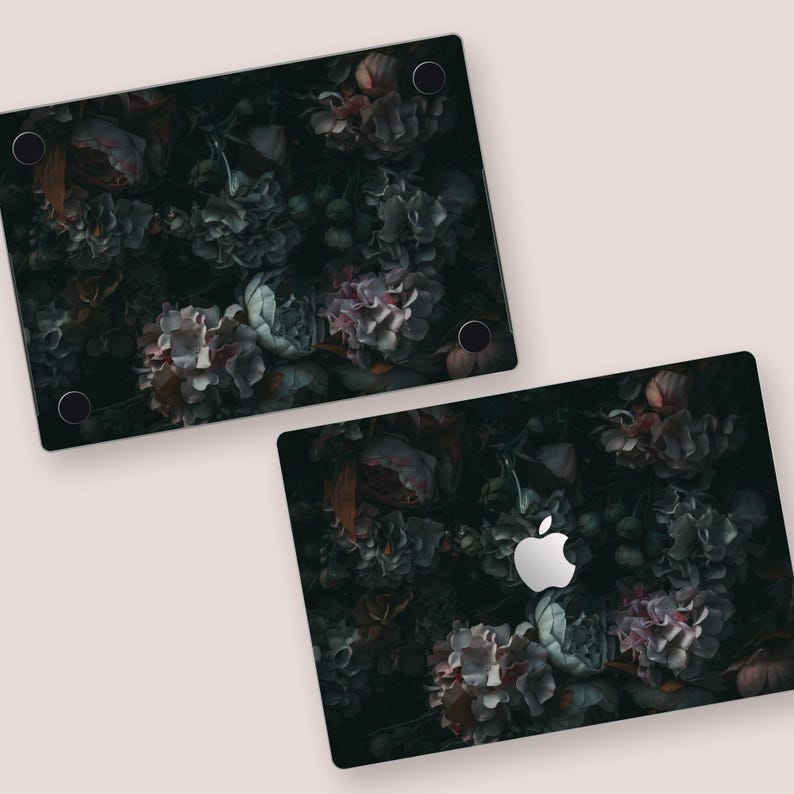 two laptops with a picture of flowers on them
