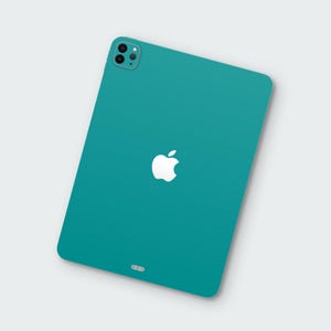 May include: A teal tablet with a white Apple logo centered on the back. The tablet has a camera module in the upper left corner and a charging port at the bottom. The device is set against a white background.