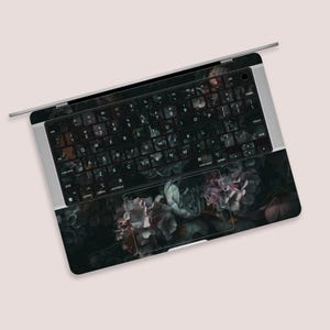 a close up of a computer keyboard with flowers on it