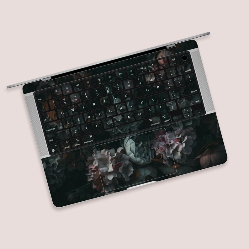 a close up of a computer keyboard with flowers on it