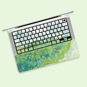 Może przedstawiać: Laptop z zielonym i niebieskim wzorem krajobrazu na klawiaturze i touchpadzie. Wzór przypomina obraz.