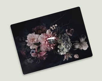 May include: A dark blue laptop skin with a floral design featuring pink, white, and green flowers. The design is reminiscent of a vintage botanical illustration.