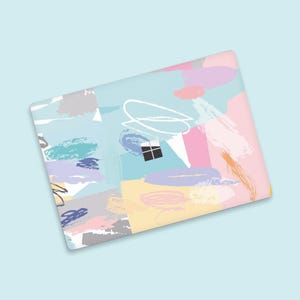 May include: A laptop skin with a colorful abstract design featuring brushstrokes and geometric shapes in shades of pink, blue, yellow, and gray.