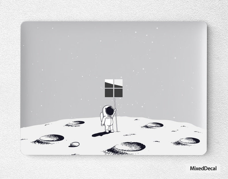 May include: A black and white illustration of an astronaut standing on the moon, holding a flag with a window icon. The moon is depicted with craters and a starry sky background.