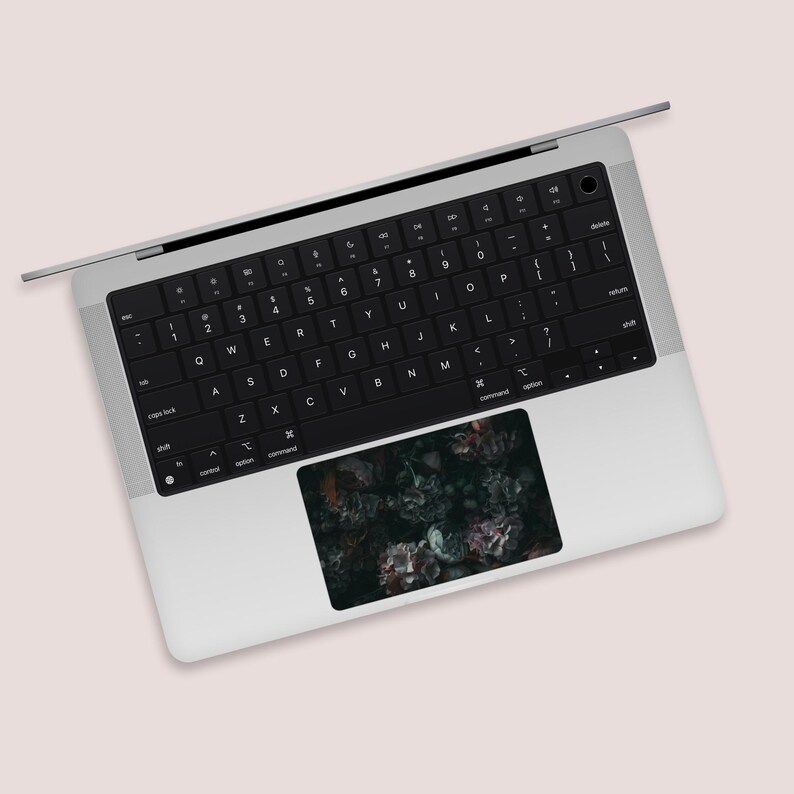 a laptop computer with a black keyboard on top of it