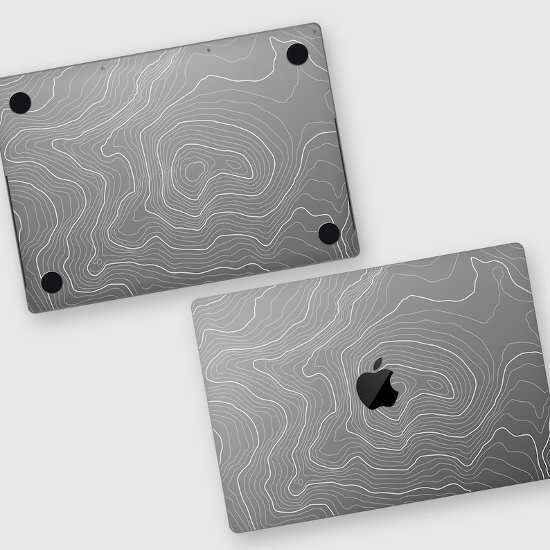 May include: A gray laptop skin with a white topographic map design. The skin has a cutout for the Apple logo.