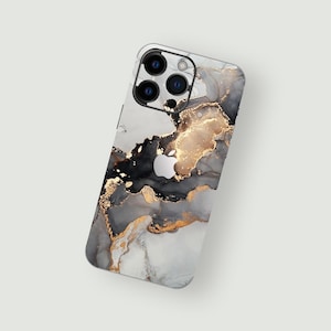 May include: A white, black, and gold marble phone case with a black Apple logo. The case has a modern, abstract design.
