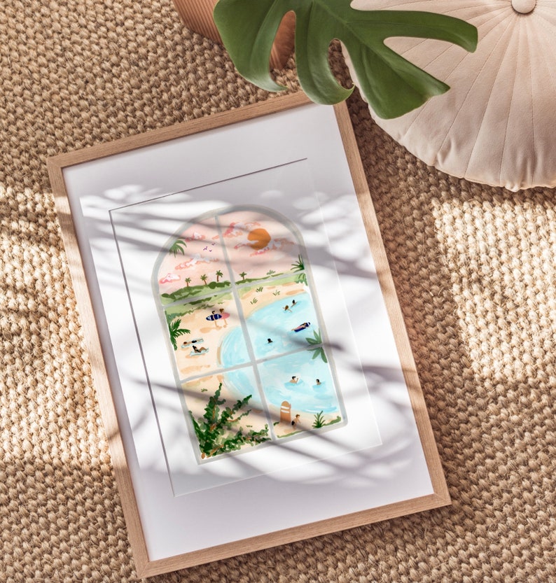 May include: A framed illustration of a beach scene viewed through a window. The window is divided into four panes, each showing a different aspect of the beach, including people swimming, sunbathing, and surfing. The sky is a soft pink and orange, and the water is a bright blue.