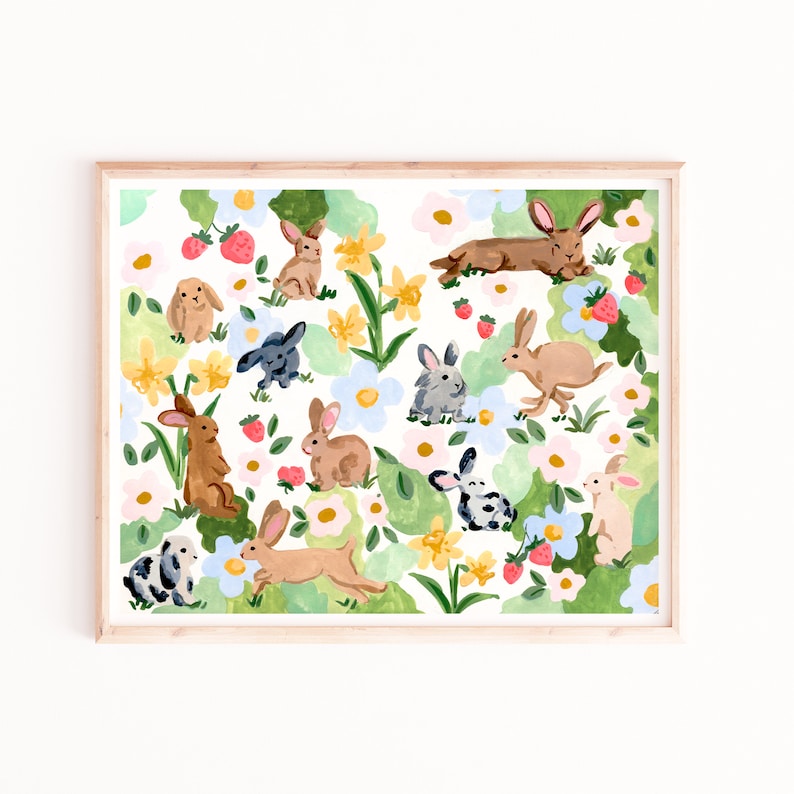 May include: Watercolor print featuring a collection of rabbits in various poses amidst a floral garden. The artwork showcases bunnies in shades of brown, gray, and black, surrounded by flowers and strawberries, all set against a white background.