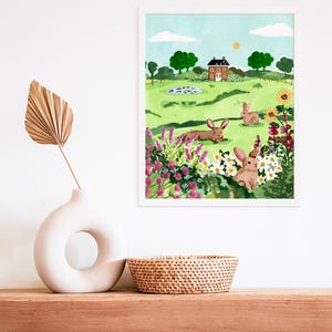 May include: A watercolor painting of a green field with a small red brick house, a pond, and three brown rabbits. The field is filled with colorful flowers and green bushes. The sky is blue with white clouds and a bright yellow sun.