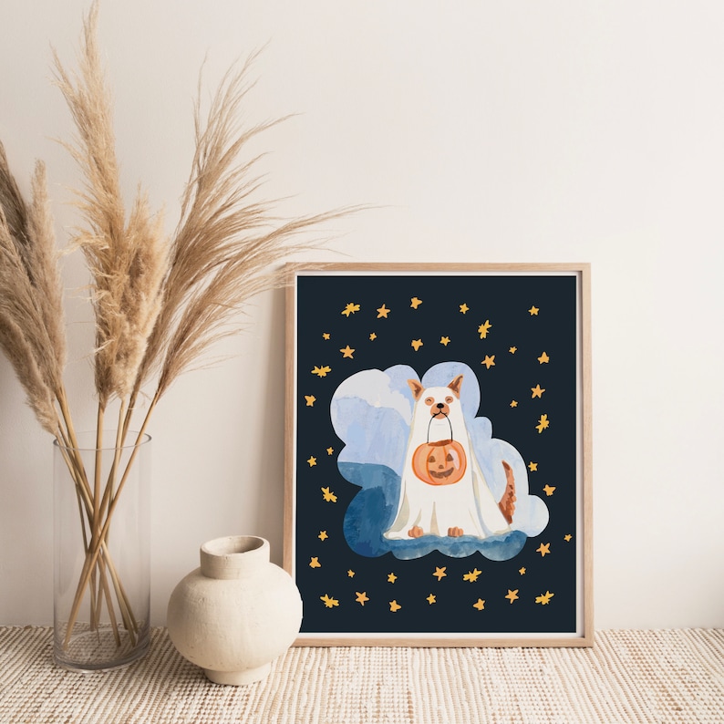 Puede incluir: Una ilustraci&oacute;n de acuarela de un perro blanco vestido de fantasma sosteniendo una calabaza tallada. El perro est&aacute; de pie sobre una nube frente a un fondo azul oscuro con estrellas doradas.