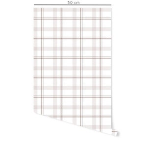 May include: A white and brown plaid wallpaper roll, 50 cm wide.