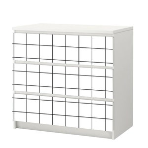 May include: White dresser with three drawers. The front of the dresser is covered in a black and white grid pattern.