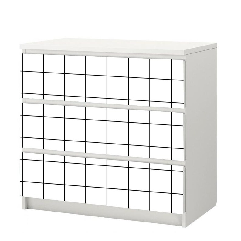 May include: White dresser with three drawers. The front of the dresser is covered in a black and white grid pattern.