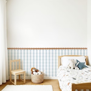 May include: A child's bedroom with a light blue and white checkered wall design, a wooden bed frame, and a small wooden chair. A wicker basket holds stuffed animals. A white rug and a scalloped brown border complete the room.