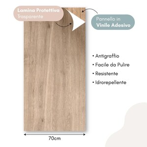 May include: A rectangular, light brown wood-grain vinyl adhesive panel, 70cm wide, with the text "Lamina Protettiva Trasparente" and "Pannello in Vinile Adesivo". Features include scratch resistance, easy cleaning, durability, and water resistance.