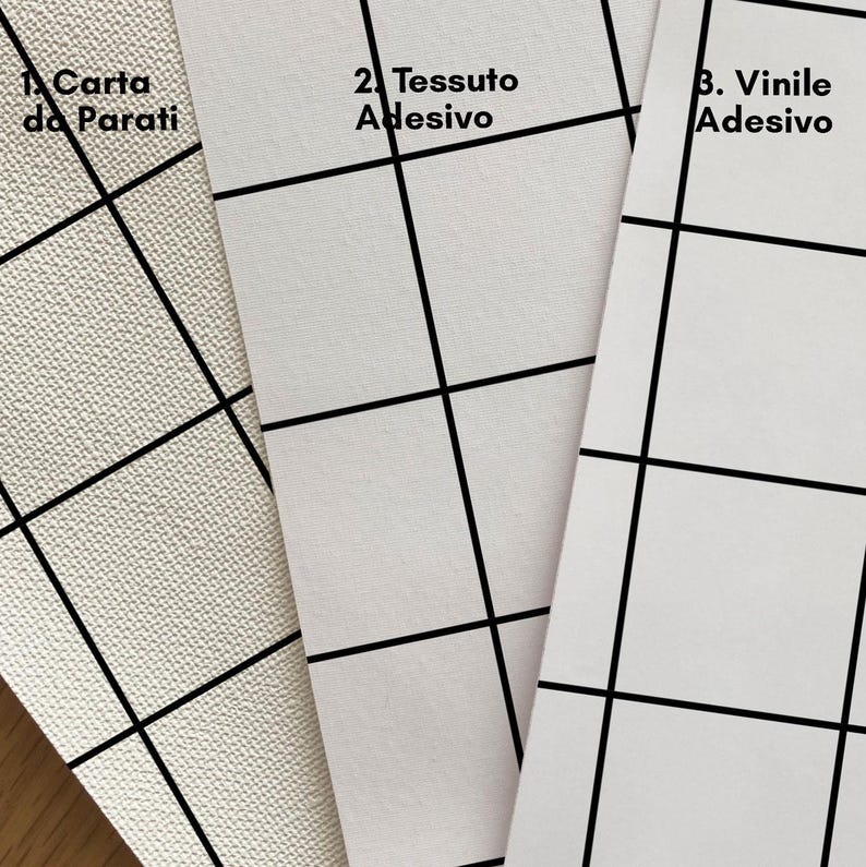 May include: Three samples of different materials for wallpaper: white paper, white fabric, and white vinyl. Each sample has a grid pattern printed on it. The text on the samples reads "1. Carta da Parati", "2. Tessuto Adesivo", and "3. Vinile Adesivo".