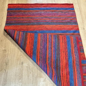60s Swedish vintage geometric wool rug woven in blue, red, orange.