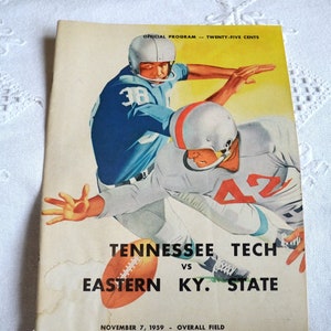 May include: Vintage football program cover featuring two players in action, one in a light blue uniform with the number 38, and the other in a gray uniform with the number 42. The program is for the Tennessee Tech vs. Eastern KY. State game, November 7, 1959.
