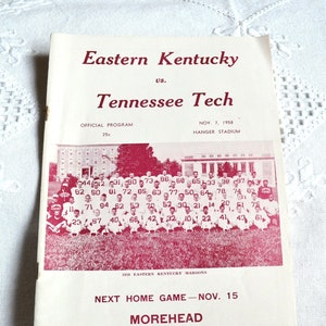 May include: A vintage football program from 1958 featuring Eastern Kentucky vs. Tennessee Tech. The cover is cream-colored with maroon text and a team photo. The program includes the date, location, and the price of 25 cents.