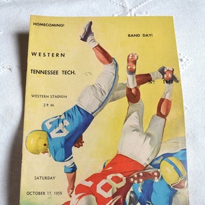 May include: Vintage football program cover with illustrations of players in action. The cover is yellow with text that reads "HOMECOMING! BAND DAY! WESTERN TENNESSEE TECH." and "SATURDAY OCTOBER 17, 1959." The program is marked "Official Program Fifteen Cents."
