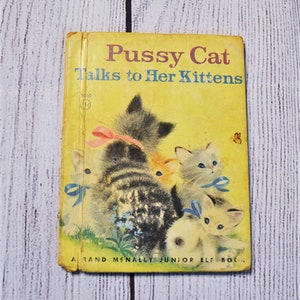 May include: Vintage children's book titled "Pussy Cat Talks to Her Kittens" with a yellow cover. The cover features illustrations of kittens with blue and pink bows. A butterfly is also visible.