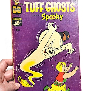 May include: Vintage comic book cover for "Tuff Ghosts" starring Spooky. The cover features a cartoon ghost and a frightened character in a turban. The comic is purple with yellow and white text.