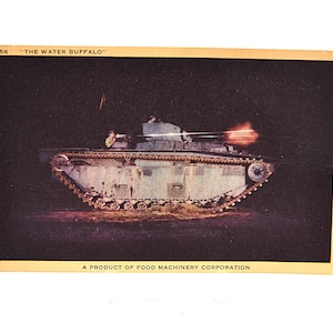 May include: Vintage postcard featuring a military tank labeled "THE WATER BUFFALO." The tank is light green and gray, with a dark background. The image shows the tank firing, with a burst of orange light. The postcard is from the Food Machinery Corporation.