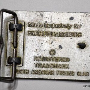 May include: Silver belt buckle with the text "Made Exclusively for NAFC LIFE MEMBERS Registered Trademark North American Fishing Club".