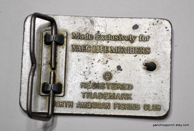 May include: Silver belt buckle with the text "Made Exclusively for NAFC LIFE MEMBERS Registered Trademark North American Fishing Club".
