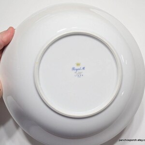 May include: White ceramic bowl with a blue and gold Royal M. Liege, Belgium mark on the bottom.