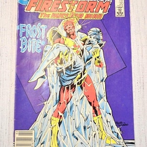 May include: A vintage comic book cover for Firestorm, The Nuclear Man, featuring the title text in orange and yellow against a purple background. The cover art depicts two figures in action, with the words "Frost Bite" in blue.