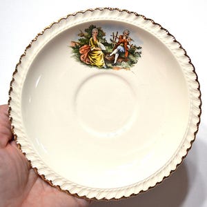 May include: A set of three ceramic canisters with lids, featuring a geometric pattern in shades of blue, white, and gray. The canisters vary in size, suitable for kitchen storage.