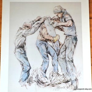 May include: A print featuring a sketch-style illustration of three figures working together to lift a large, rectangular object. The figures are rendered in muted blue, tan, and grey tones with visible ink outlines on a white background.