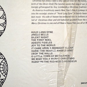 May include: A vintage Christmas album cover with a black and white decorative design on the left. The album lists classic Christmas carols such as "Silent Night" and "Jingle Bells". The text also includes "Merry Christmas".