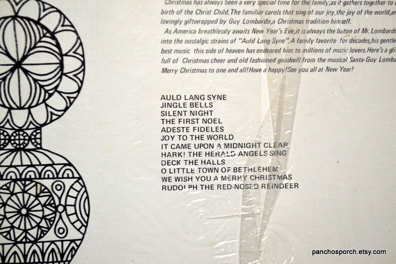 May include: A vintage Christmas album cover with a black and white decorative design on the left. The album lists classic Christmas carols such as "Silent Night" and "Jingle Bells". The text also includes "Merry Christmas".