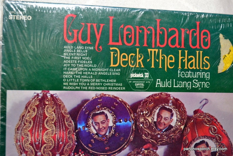 May include: A vintage vinyl record album cover for "Deck The Halls" by Guy Lombardo, featuring Christmas songs. The cover is green with red and yellow text. Ornaments with a portrait are at the bottom.