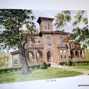 May include: A watercolor print of a large brick building, likely a library, with multiple windows and a tower. The building is surrounded by green grass, trees, and a blue sky. The text "The Library" is at the bottom.