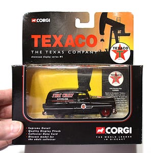 May include: A black Corgi diecast 1953 Pontiac panel van model in its original packaging. The vehicle features red wheels and Texaco Fire Chief Gasoline branding. The box displays the Texaco logo, an oil derrick graphic, and descriptive text.