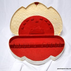 May include: A set of three ceramic mugs with a speckled, matte finish. The mugs are in shades of cream, light gray, and dark gray. Each mug has a simple, modern design and a rounded handle. The mugs are stacked on top of each other.