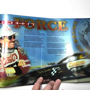 May include: A glossy magazine spread featuring John Force, a race car driver wearing a white cap and a red, white, and black racing jacket with sponsor logos. The text includes the title John Force Driver of the Year and biographical details.
