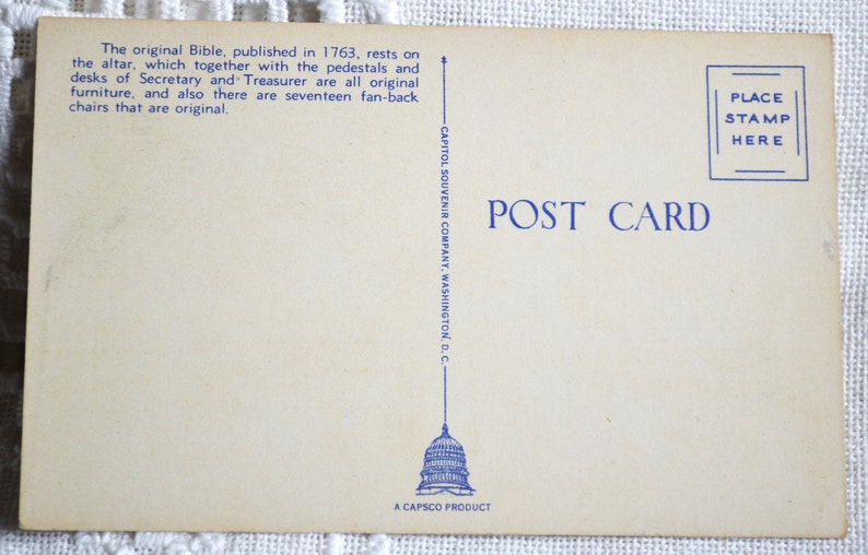 May include: A vintage postcard featuring a blue illustration of the US Capitol building with the text "POST CARD" and "PLACE STAMP HERE" in blue. The back of the postcard has the text "CAPITOL SOUVENIR COMPANY, WASHINGTON, D.C." and "A CAPSCO PRODUCT".