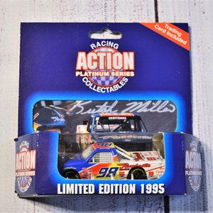 May include: A 1995 limited edition Action Platinum Series die-cast race truck in blue, white, and red with the number 98. The packaging features the text Racing Action Platinum Series, Butch Miller, and Trading Card Included on a blue background.