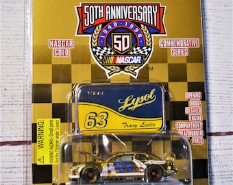 May include: A Racing Champions 50th Anniversary NASCAR Gold commemorative series die-cast car, packaged in a clear plastic case. The car is gold with the number 63 and Lysol branding. The packaging includes the text "Adult Collectible".