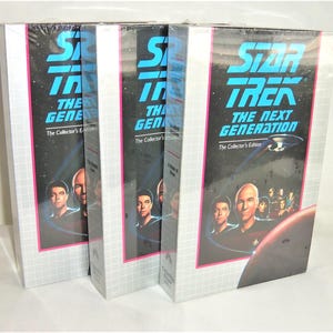 May include: Three identical Star Trek: The Next Generation The Collector's Edition VHS box sets. Each box features a black background with a blue title, a graphic of the Enterprise starship, a red planet, and a cast portrait in the foreground.
