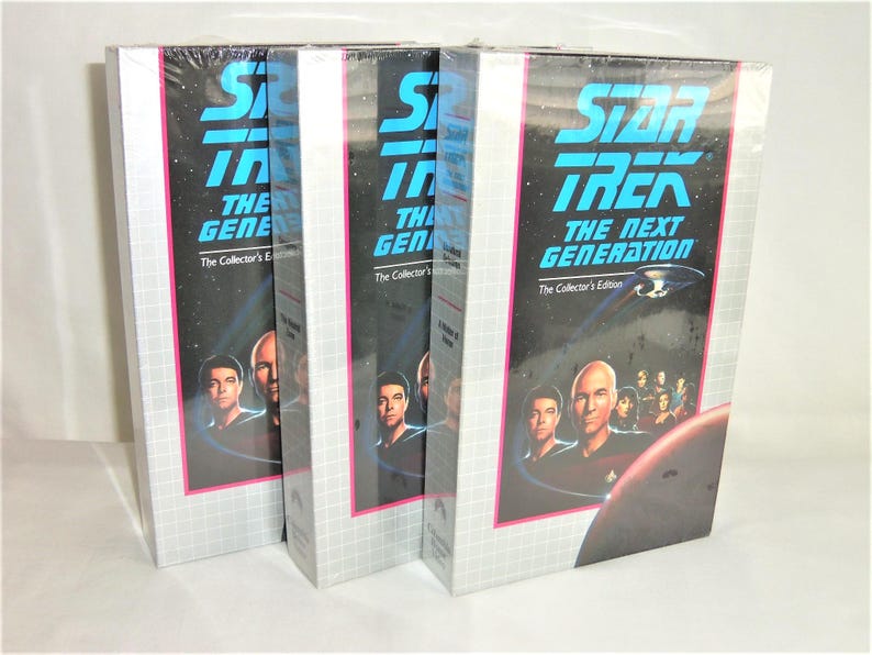 May include: Three identical Star Trek: The Next Generation The Collector's Edition VHS box sets. Each box features a black background with a blue title, a graphic of the Enterprise starship, a red planet, and a cast portrait in the foreground.